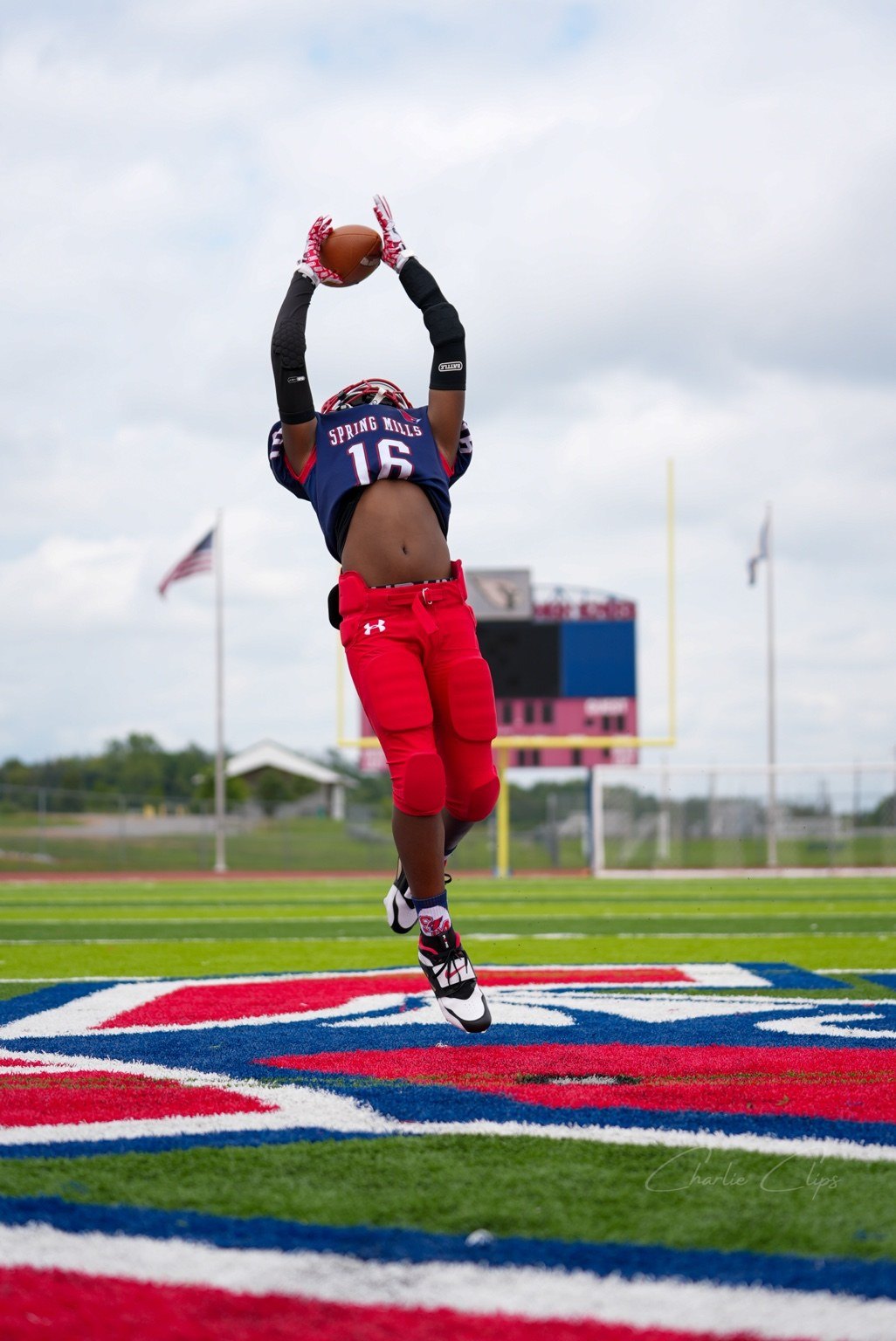 Youth football player jumping for a catch