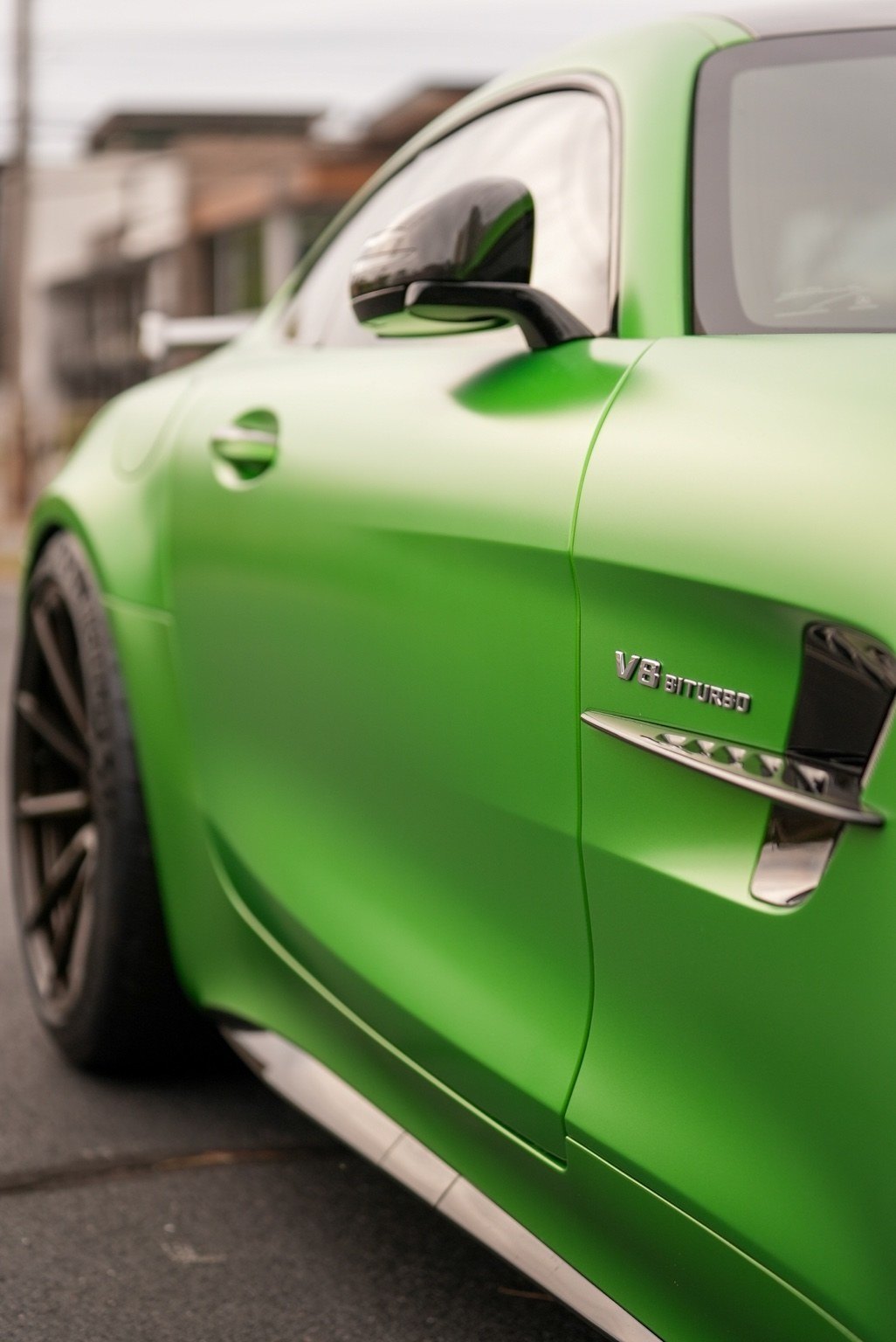 Green performance car side detail