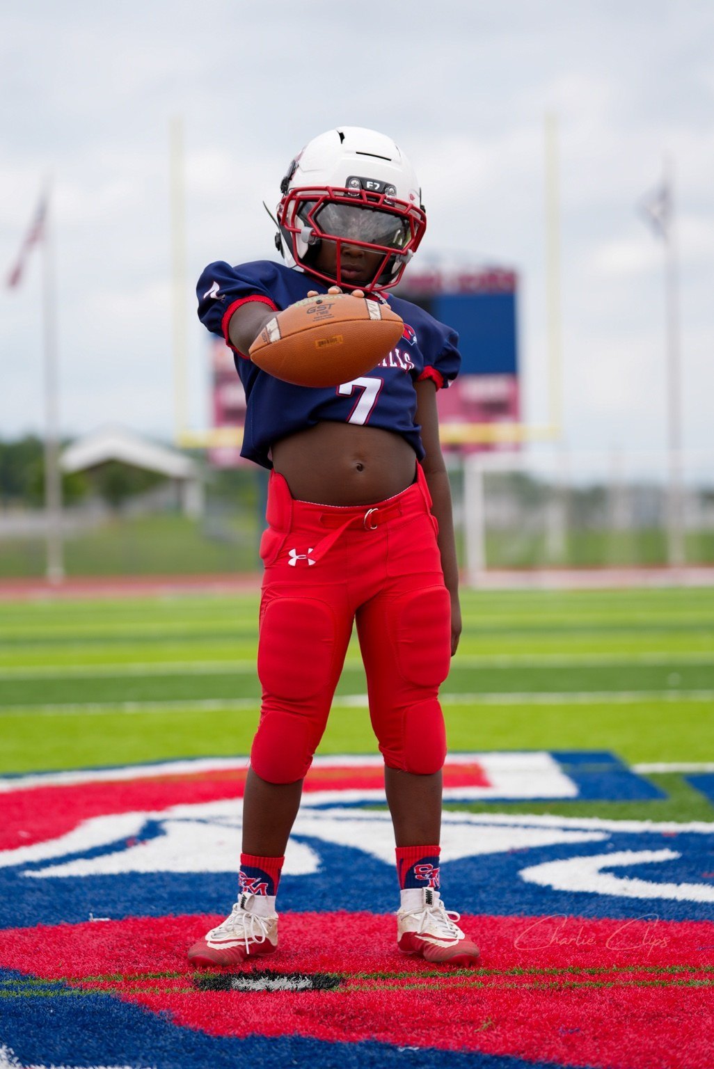Football player holding a ball toward the camera