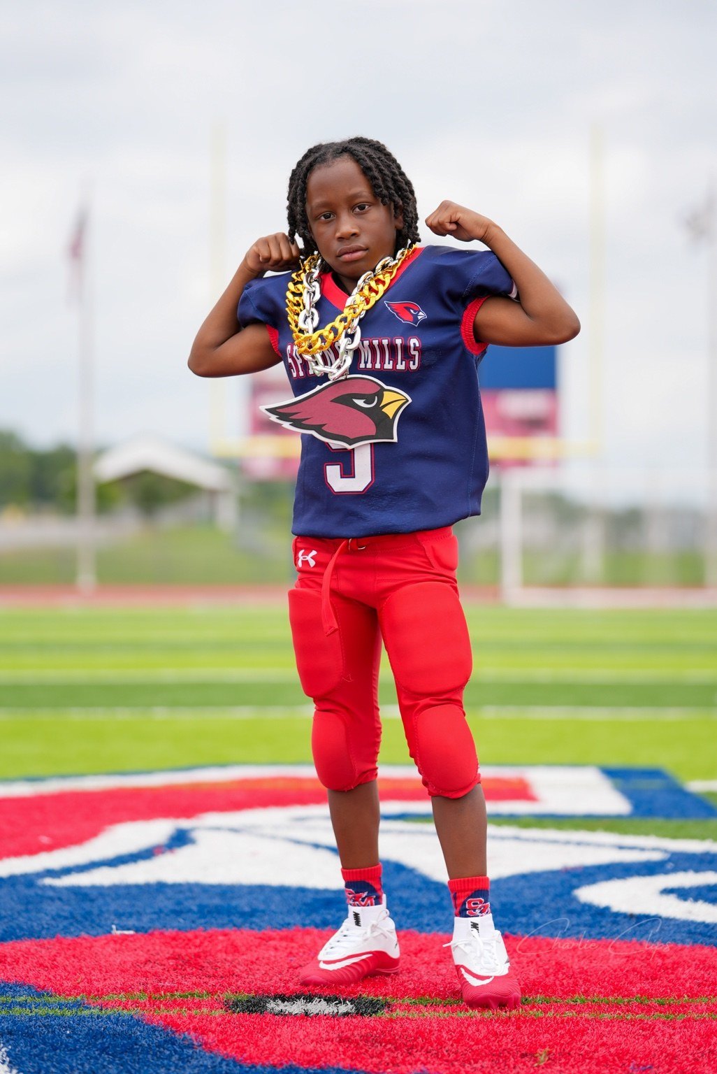 Youth football player flexing on the field