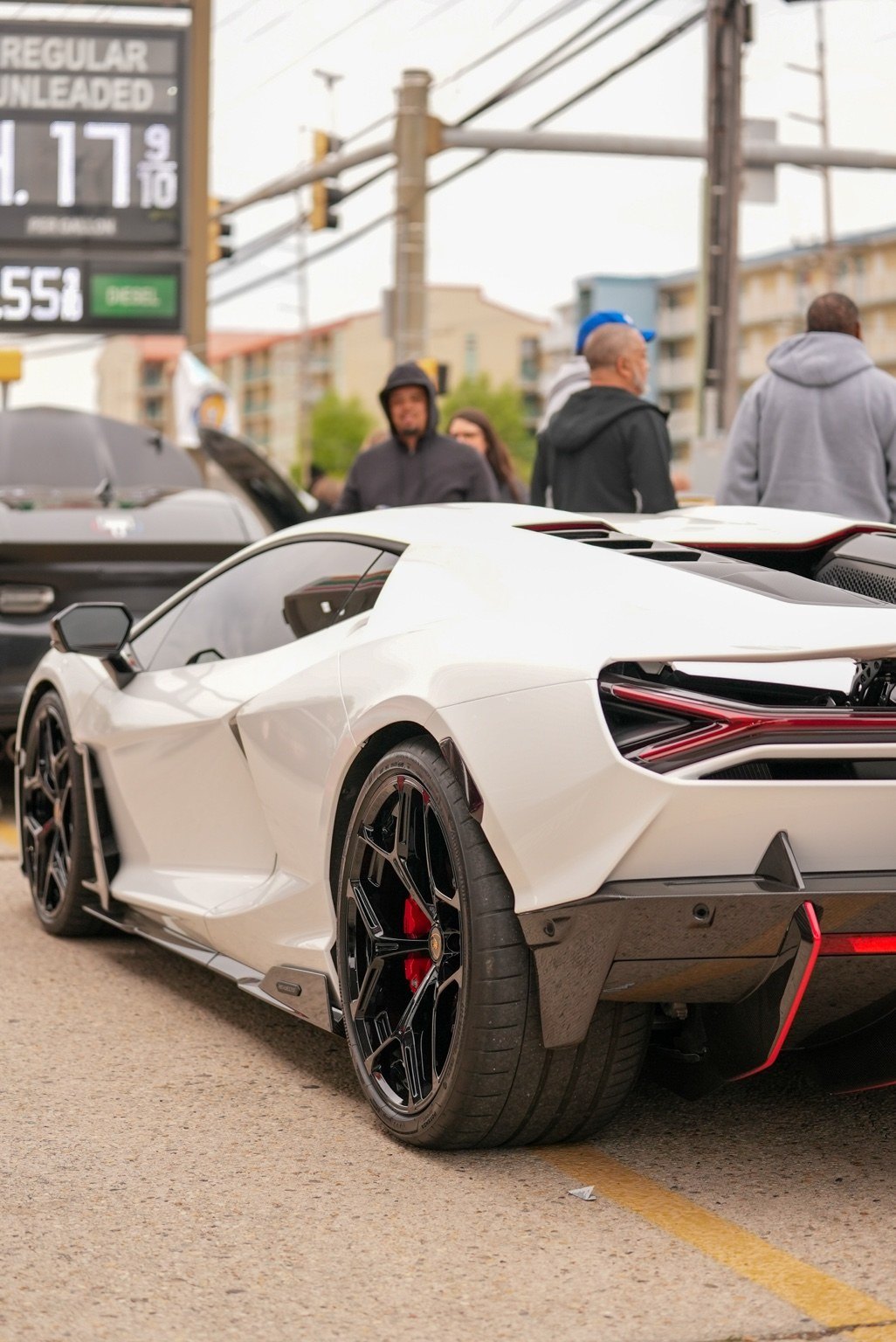 White exotic sports car rear three-quarter view