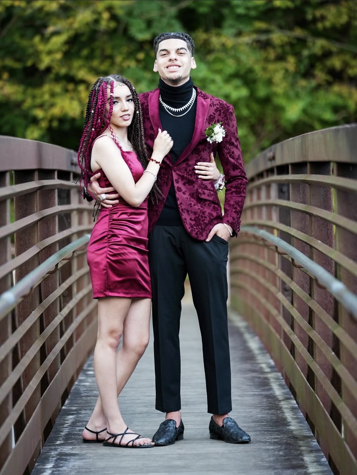 Prom couple full-length portrait on a bridge
