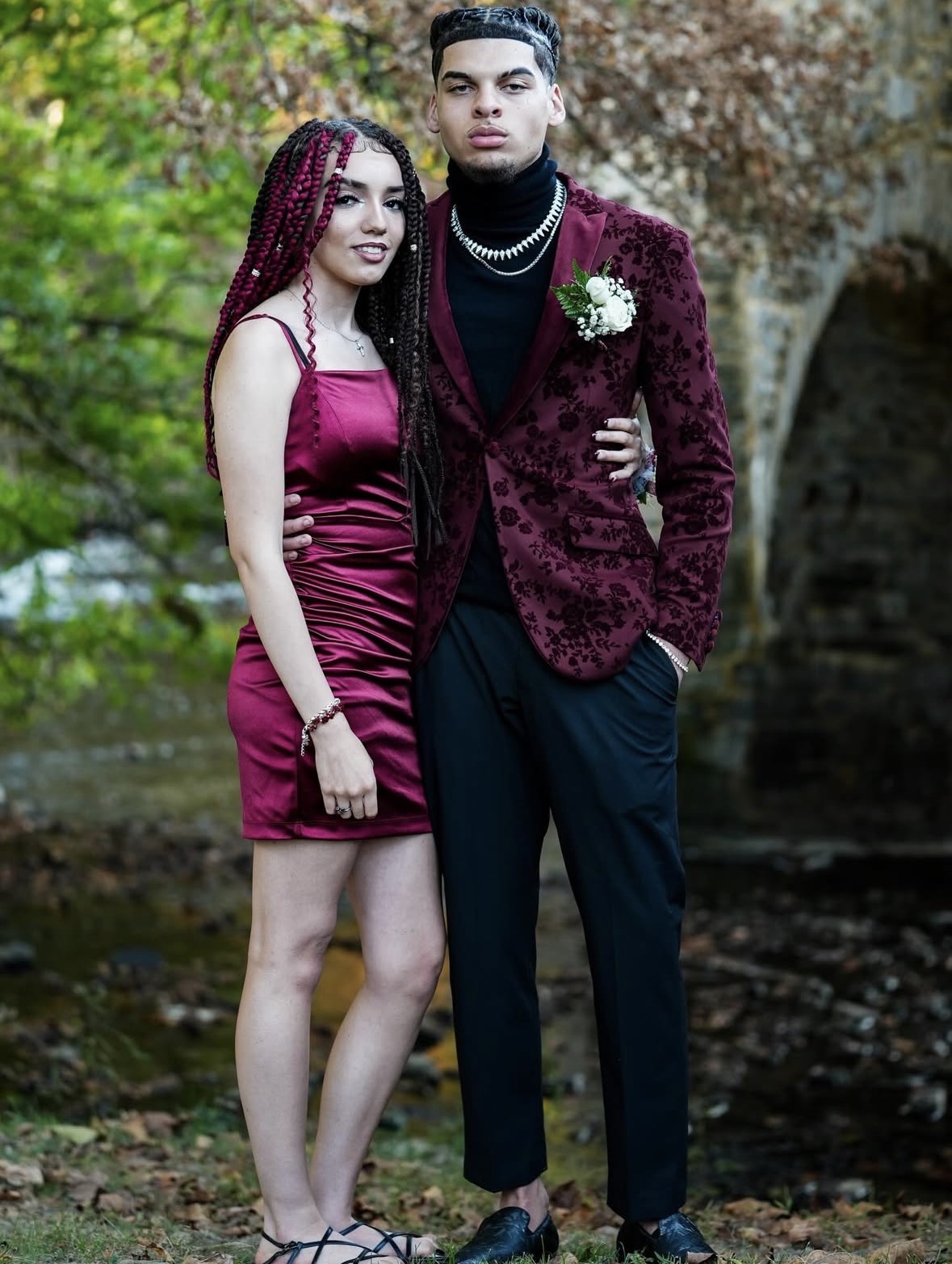 Prom couple portrait near a historic stone bridge